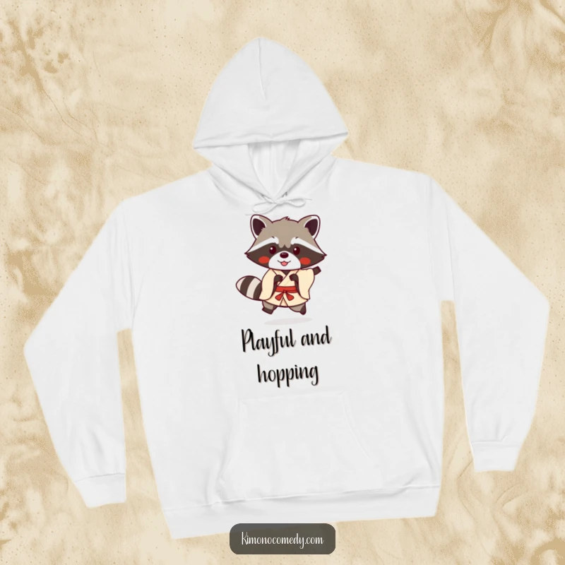 Funny kawaii raccoon in a simple kimono doing a playful hop on a cozy hoodie, offering warmth and humorous anime cheer.