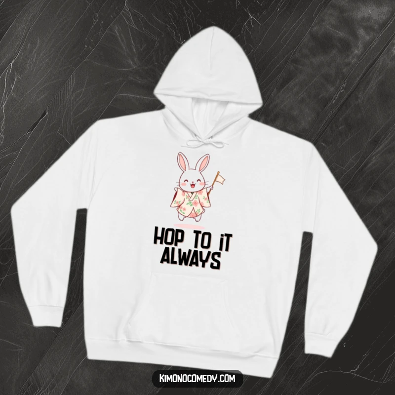 Funny hoodie featuring a rabbit in a floral kimono hopping excitedly and waving a flag, combining comfort with festive humor.