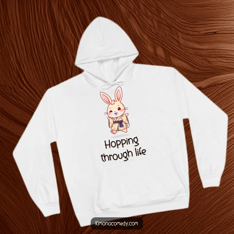Funny hooded sweatshirt showcasing a cute rabbit in a floral kimono, joyfully hopping and spreading good vibes, perfect for cozying up.
