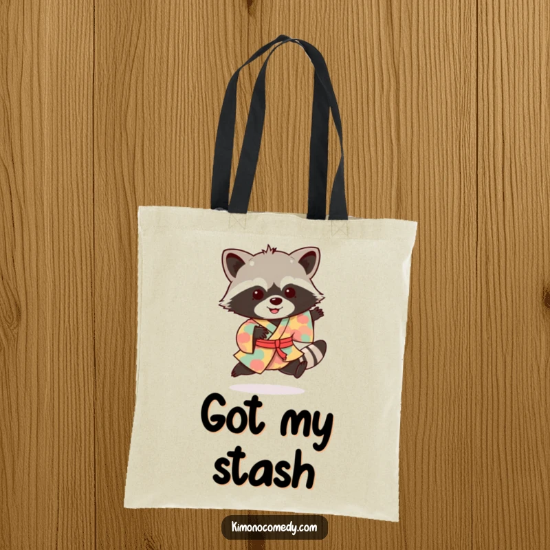 Funny raccoon tote bag featuring a delighted bandit in a colorful kimono, performing a joyful hop.